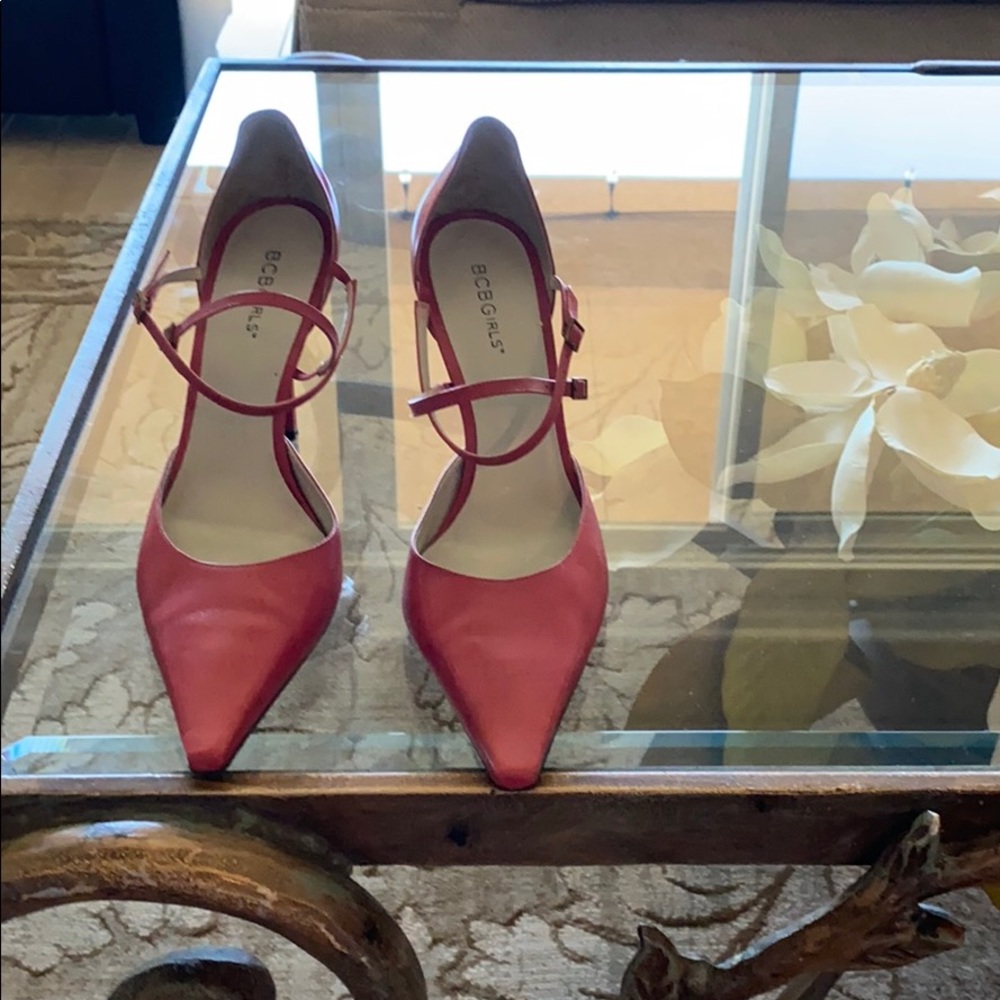 Coral pointy high heels with straps.